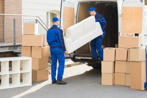 Man with van team loading furniture safely in Whitecity