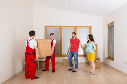 Moving van and packed boxes outside a White City property