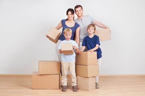 Packed moving boxes and furniture ready for collection in White City
