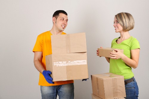Removal team handling boxes and furniture for a White City flat move