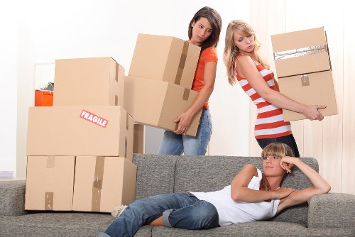 Loading furniture into a van near White City apartment buildings